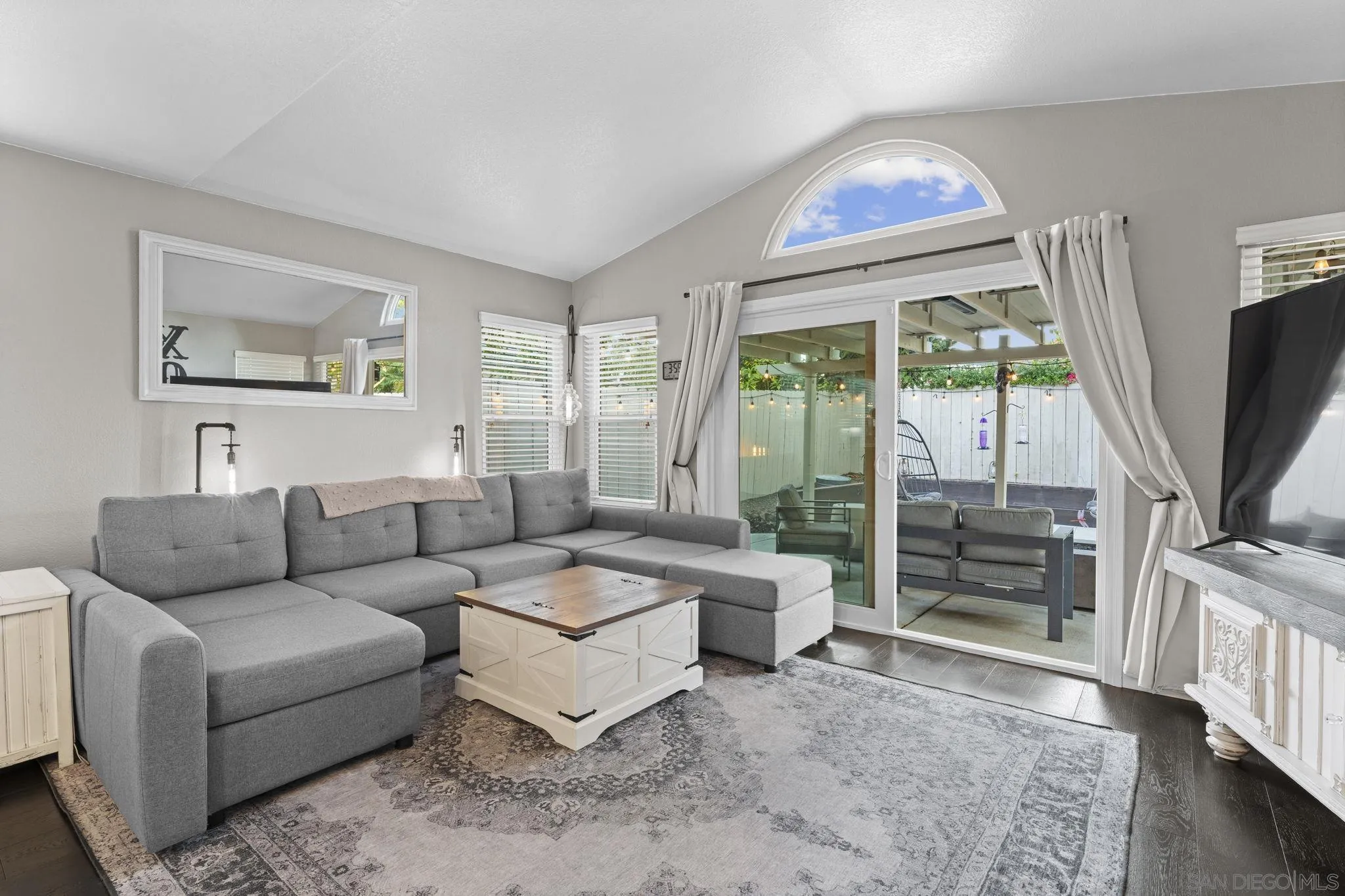 1846 Corte Pulsera Oceanside, CA 92056 - Photo 9 of 30 a living room with furniture a flat screen tv and a floor to ceiling window