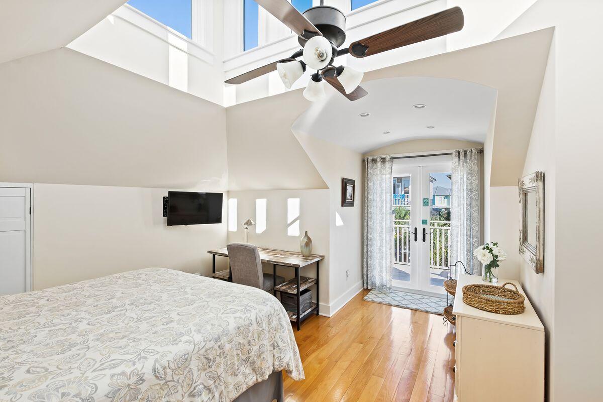 43 Sand Flea Drive Inlet Beach, FL 32461 - Photo 24 of 49 a bedroom with a bed a large window and a flat screen tv