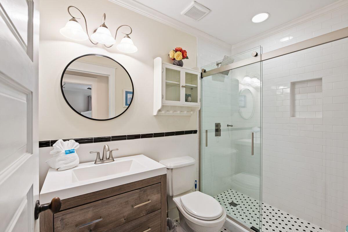 43 Sand Flea Drive Inlet Beach, FL 32461 - Photo 27 of 49 a bathroom with a sink a mirror a toilet and shower