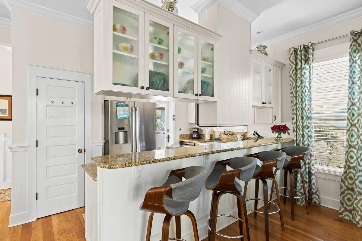 43 Sand Flea Drive Inlet Beach, FL 32461 - Photo 28 of 49 a dining hall with stainless steel appliances kitchen island granite countertop a dining table and chairs