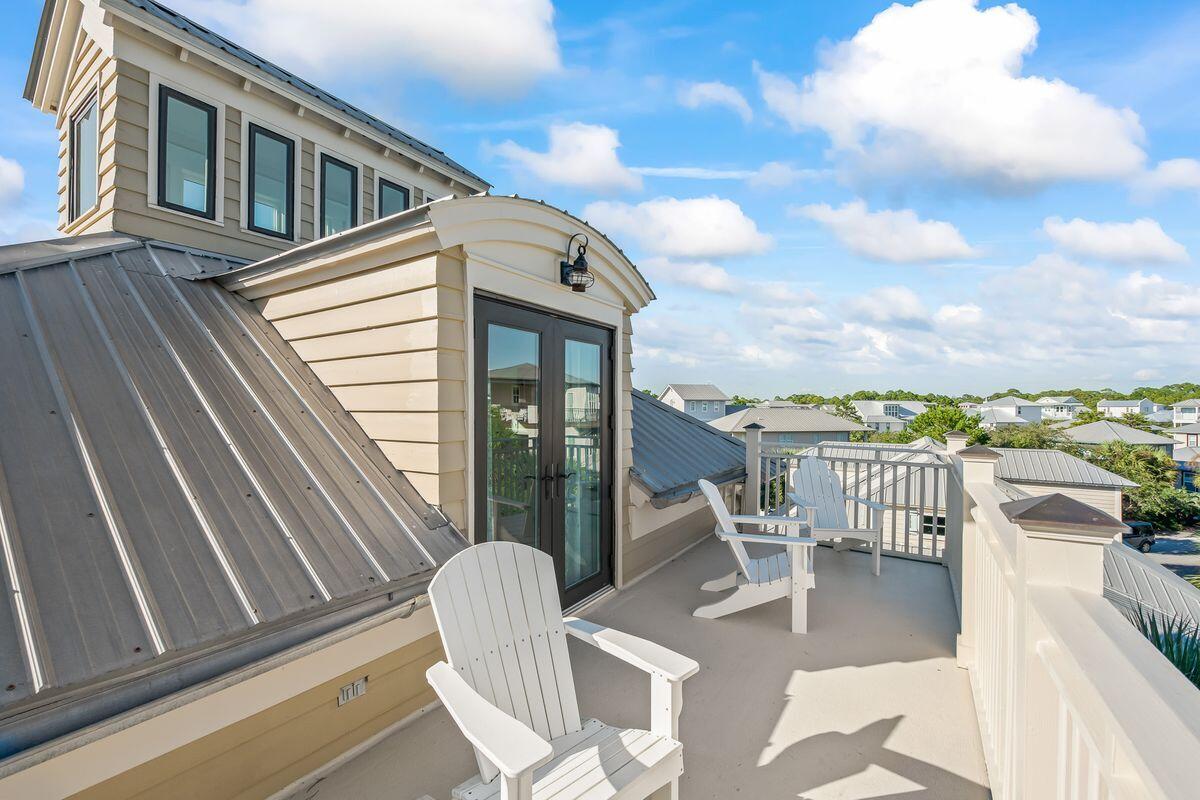 43 Sand Flea Drive Inlet Beach, FL 32461 - Photo 36 of 49 a view of a balcony with table and chairs