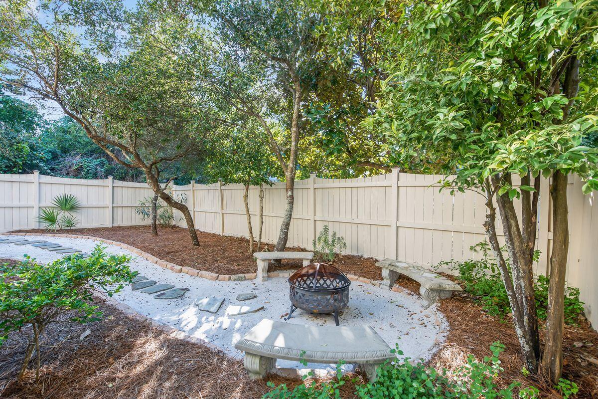 43 Sand Flea Drive Inlet Beach, FL 32461 - Photo 45 of 49 a view of a backyard with table and chairs potted plants and large tree