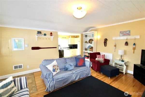 a living room with furniture and wooden floor