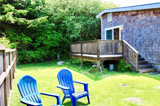 a view of a wooden chairs and table in the patio