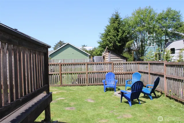 a view of a house with a deck and a yard