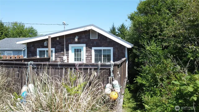 a view of a house with a yard and potted plants
