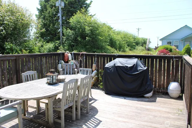 a view of a chairs and table on the roof deck