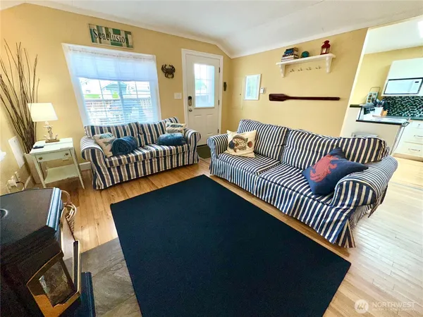 a living room with furniture stairs and a window