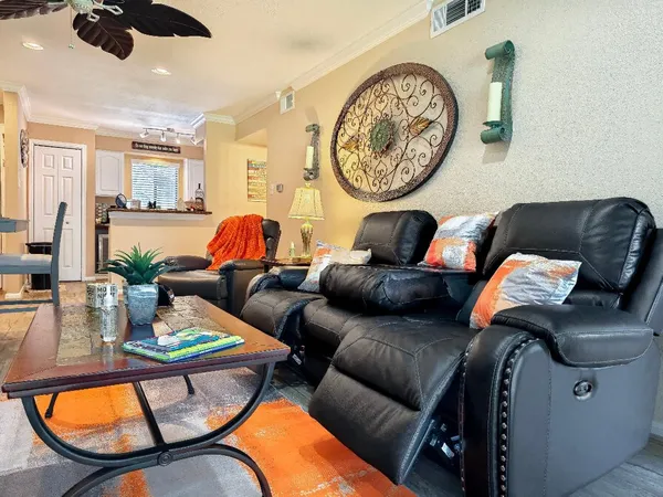 a living room with furniture and a mirror