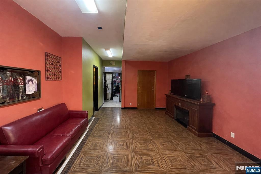 220 Bloomfield Avenue Montclair, NJ 07042 - Photo 5 of 13 a living room with furniture a flat screen tv and kitchen view