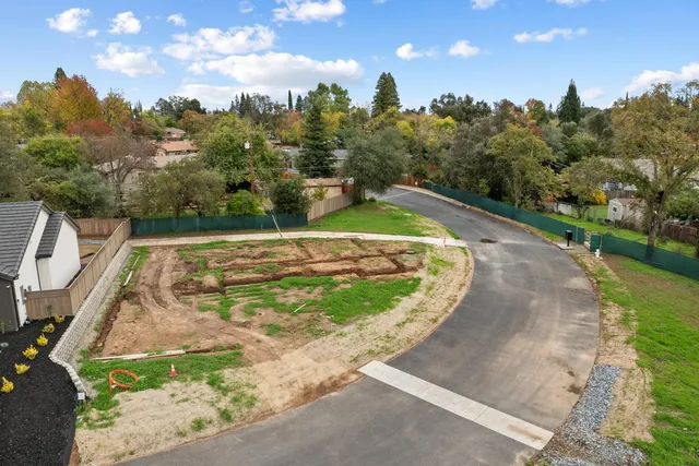 a view of a swimming pool with a yard and lake view