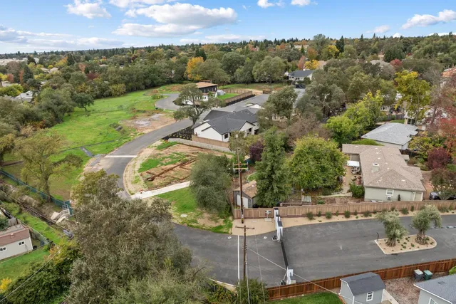 an aerial view of a house with a yard