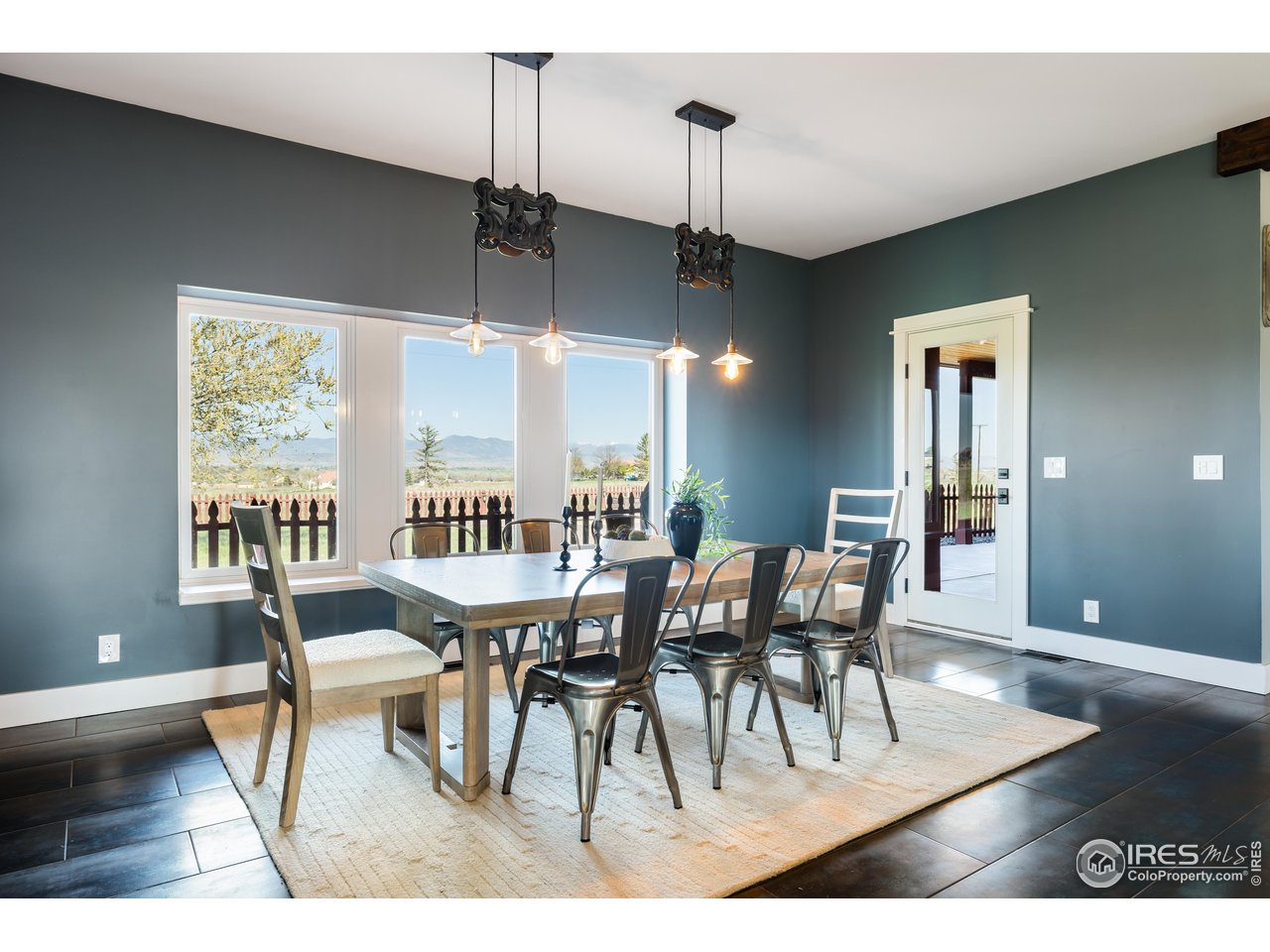 2139 County Road 15 Berthoud, CO 80513 - Photo 12 of 39 a dining room with furniture a chandelier and wooden floor