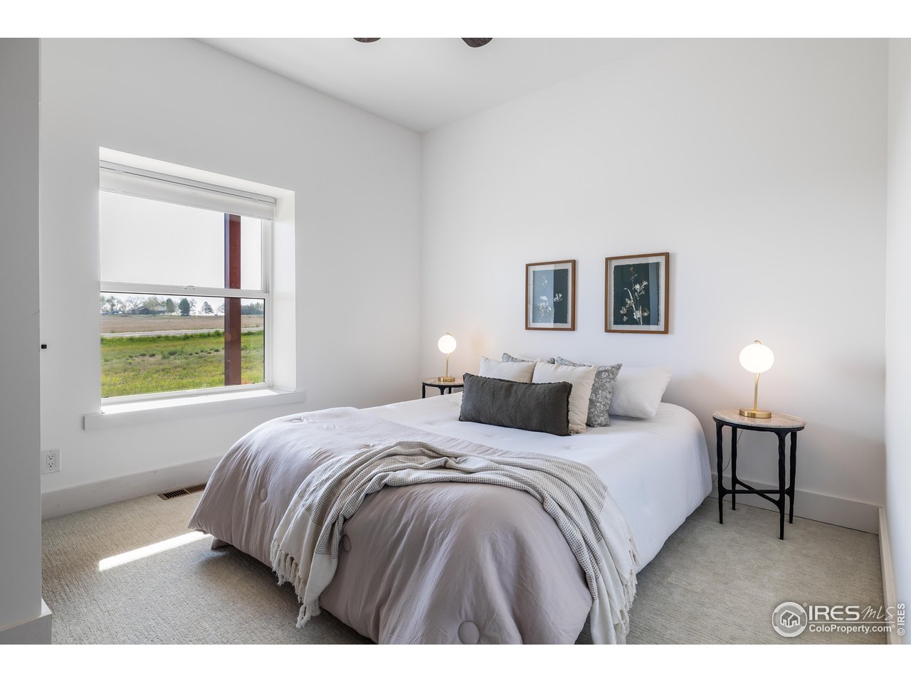 2139 County Road 15 Berthoud, CO 80513 - Photo 23 of 39 a bedroom with a bed a painting and a window
