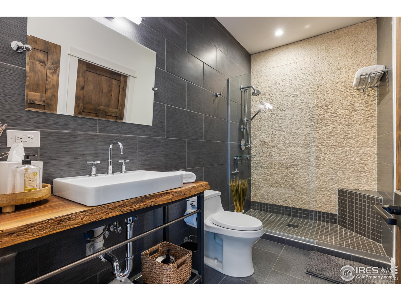 2139 County Road 15 Berthoud, CO 80513 - Photo 24 of 39 a bathroom with a sink toilet a mirror and shower