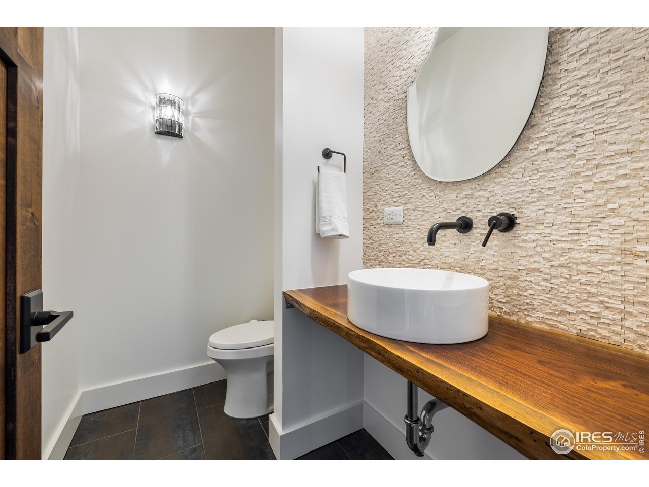 2139 County Road 15 Berthoud, CO 80513 - Photo 26 of 39 a bathroom with a toilet a sink and mirror
