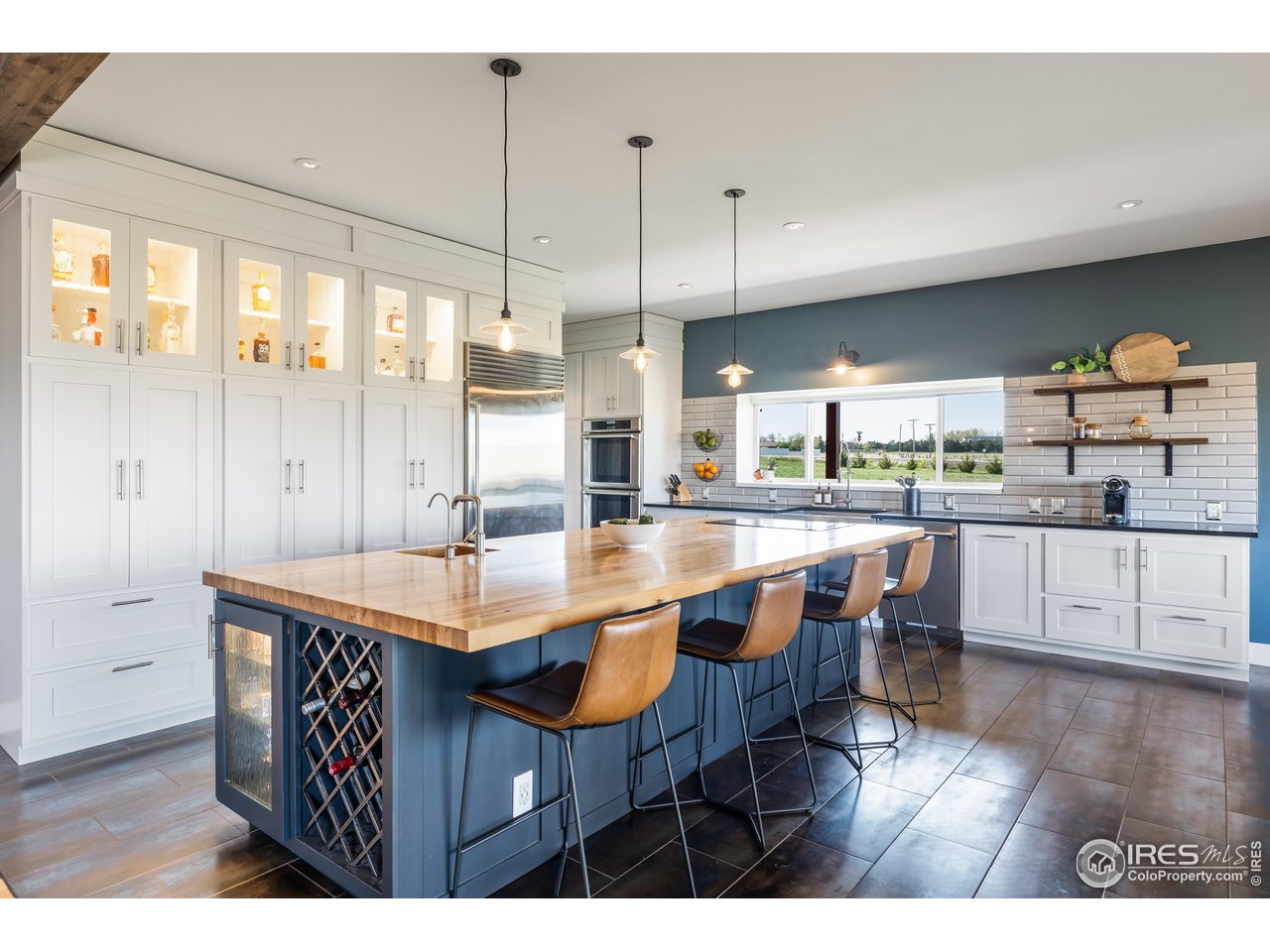 2139 County Road 15 Berthoud, CO 80513 - Photo 6 of 39 a dining hall with stainless steel appliances kitchen island granite countertop a table chairs and a view of living room