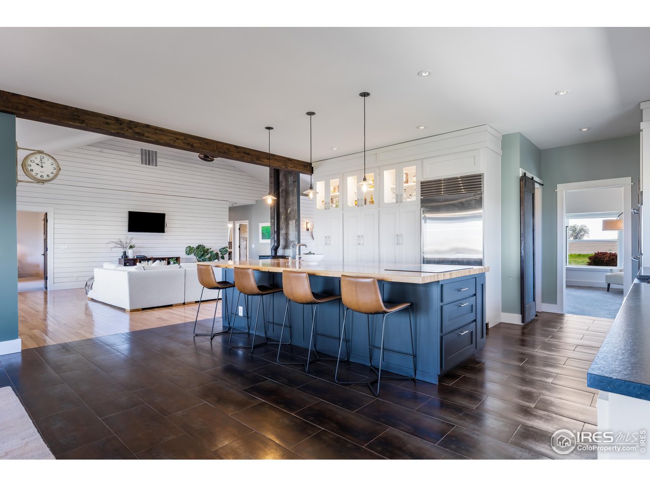 2139 County Road 15 Berthoud, CO 80513 - Photo 8 of 39 a living room with kitchen island furniture and a chandelier