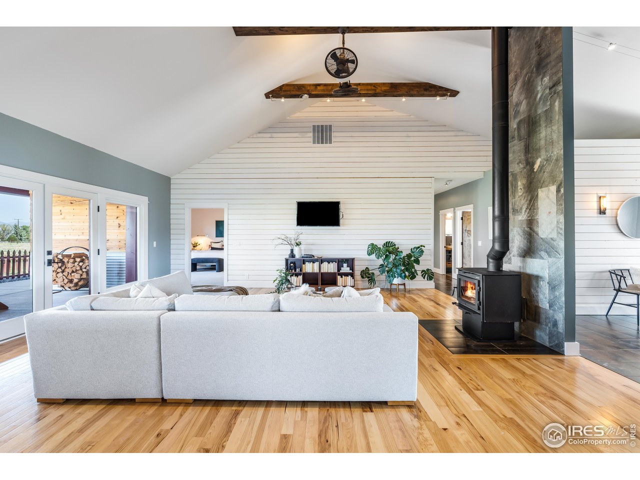 2139 County Road 15 Berthoud, CO 80513 - Photo 9 of 39 a living room with furniture and a flat screen tv
