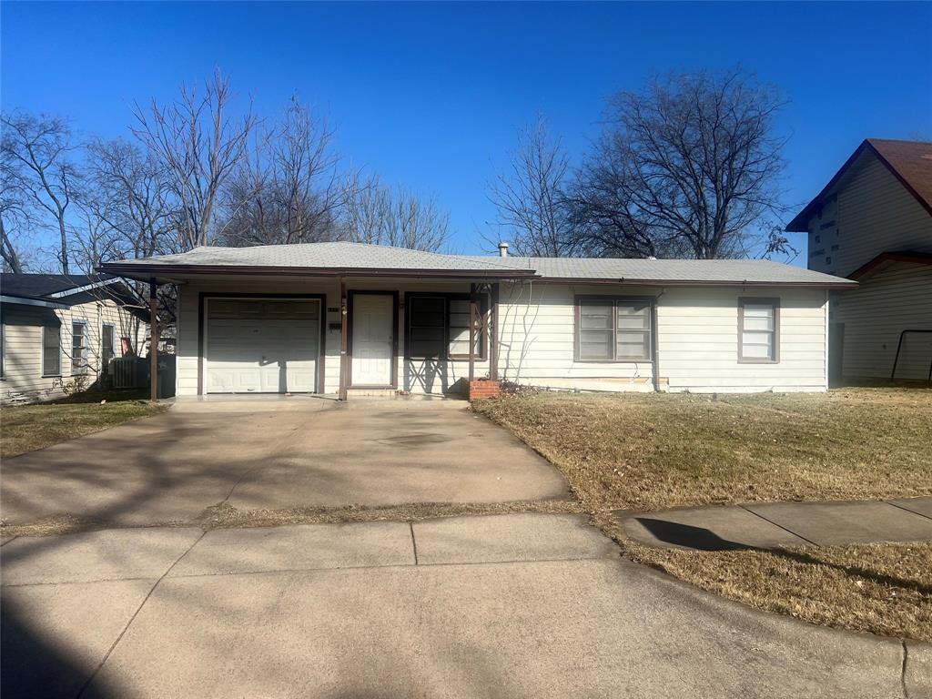 Ranch-style house featuring concrete driveway, an attached garage, and a porch