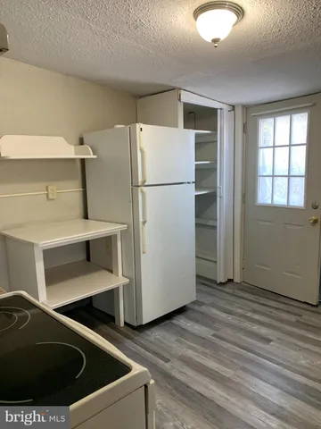 a kitchen with a refrigerator and window