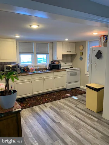 a kitchen with stainless steel appliances granite countertop a sink stove and wooden cabinets