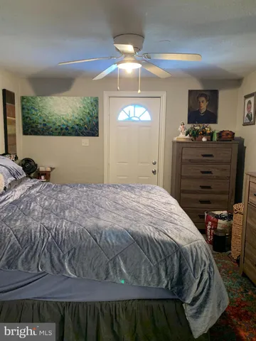 a bedroom with a bed and a flat tv screen