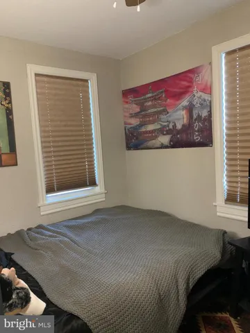 a bed sitting in a bedroom next to a window