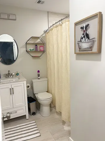 a bathroom with a toilet a sink and a mirror