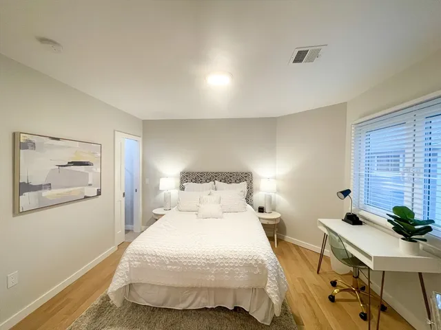 a bedroom with a bed and a table in it