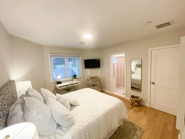 a bedroom with a bed and a flat screen tv