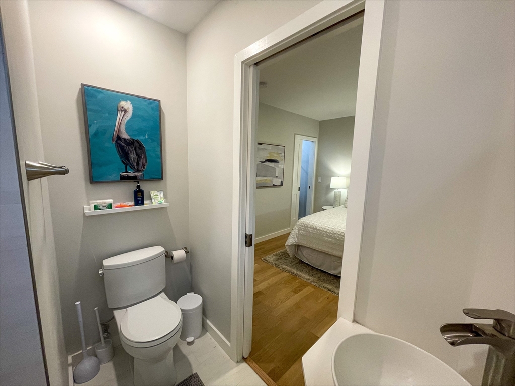 75 Thorndike Street, Unit 2FURNISHED Cambridge, MA 02141 - Photo 16 of 16 a bathroom with a toilet sink and mirror