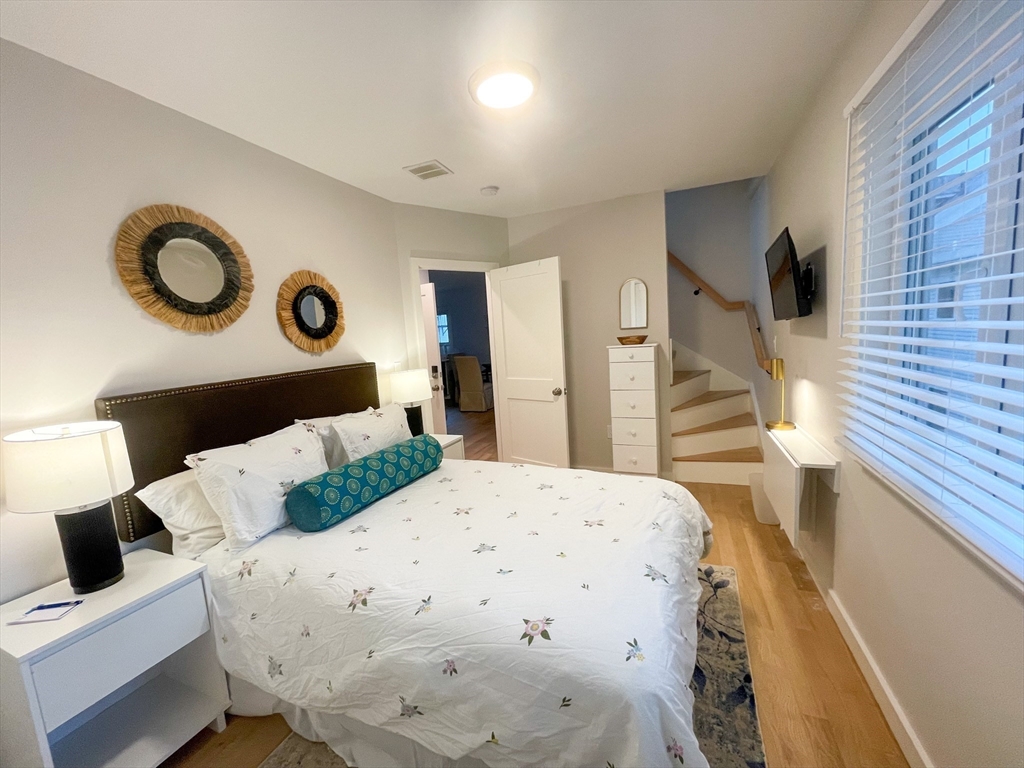 75 Thorndike Street, Unit 2FURNISHED Cambridge, MA 02141 - Photo 10 of 16 a bedroom with a bed and cabinets