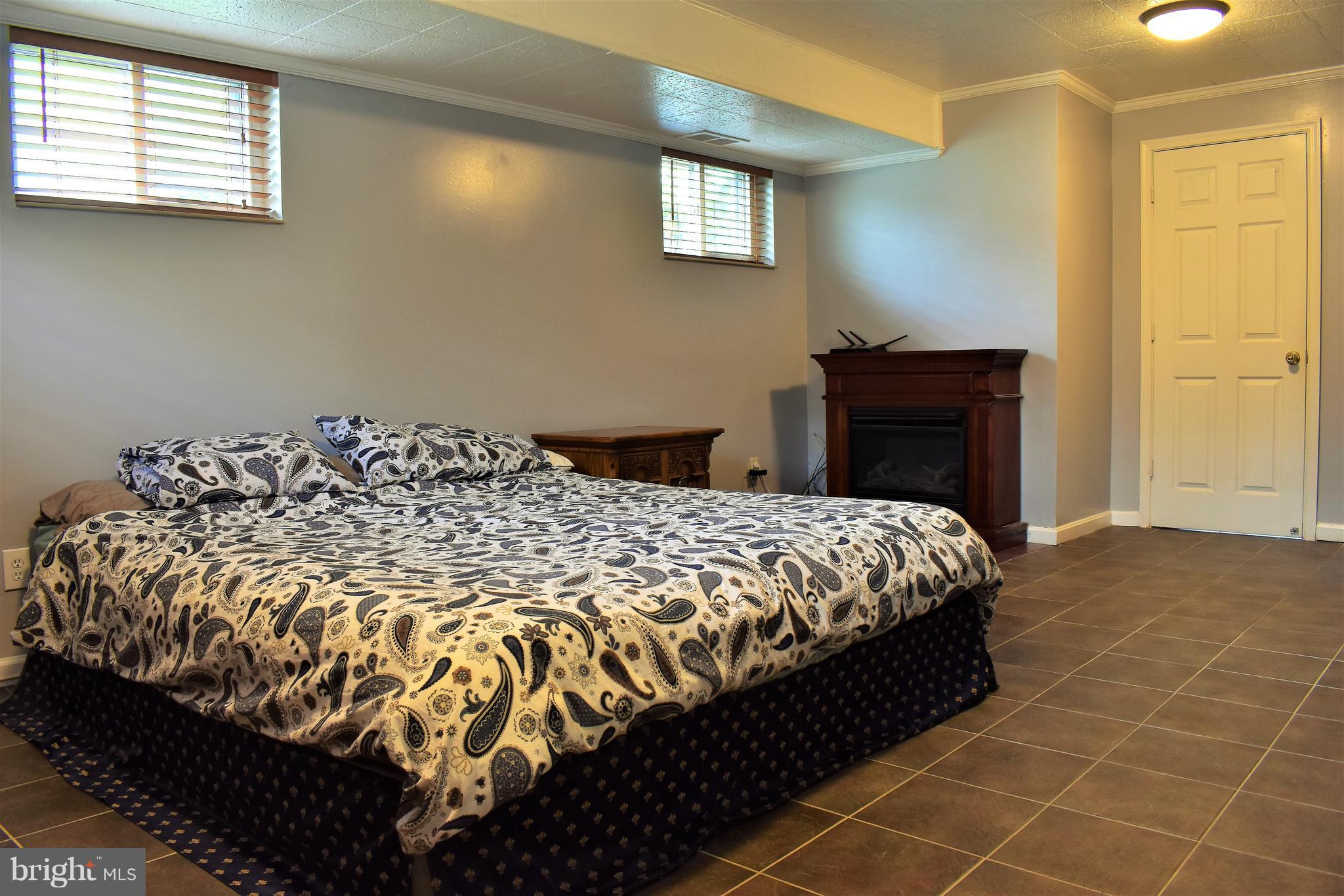 5810 Channing Road Springfield, VA 22150 - Photo 15 of 21 a bed sitting in a bedroom next to a window and a bathroom