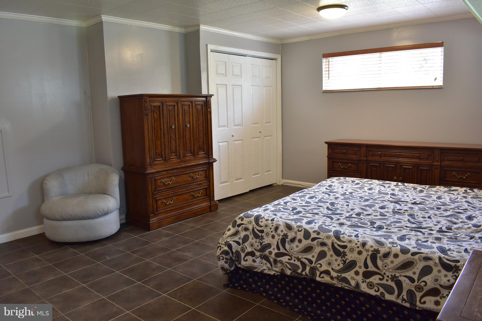 5810 Channing Road Springfield, VA 22150 - Photo 16 of 21 a bedroom with a bed and a chair