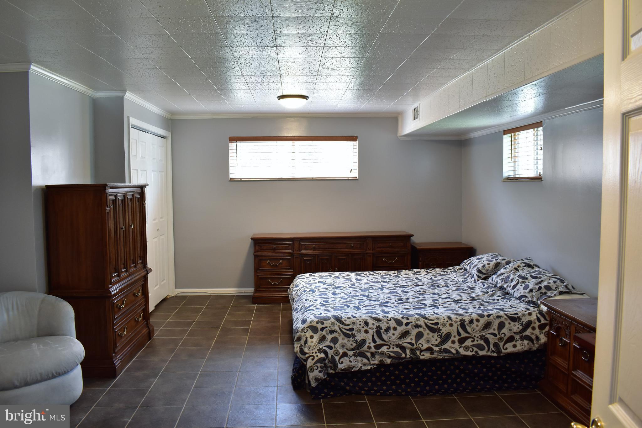 5810 Channing Road Springfield, VA 22150 - Photo 17 of 21 a bedroom with a bed and wooden floor