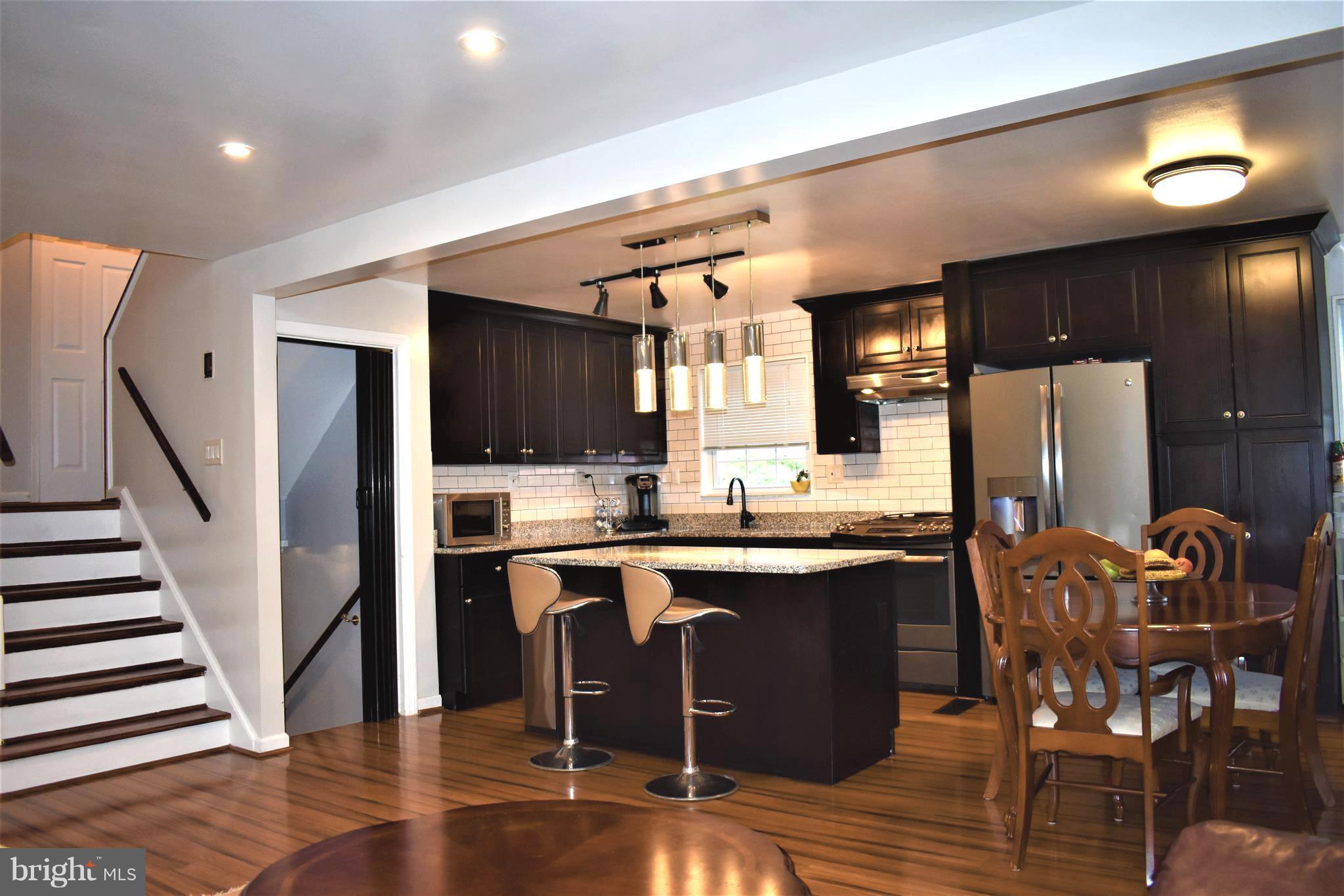 5810 Channing Road Springfield, VA 22150 - Photo 4 of 21 a kitchen with stainless steel appliances granite countertop a sink and a refrigerator