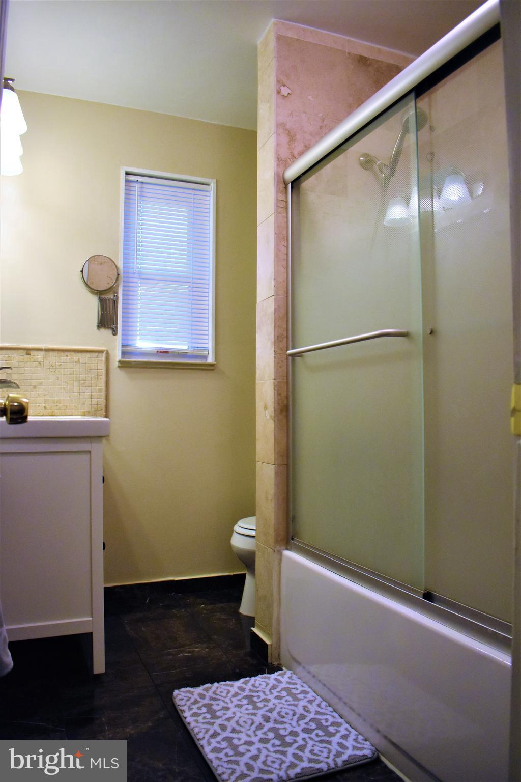 5810 Channing Road Springfield, VA 22150 - Photo 10 of 21 a bathroom with a bathtub and a toilet