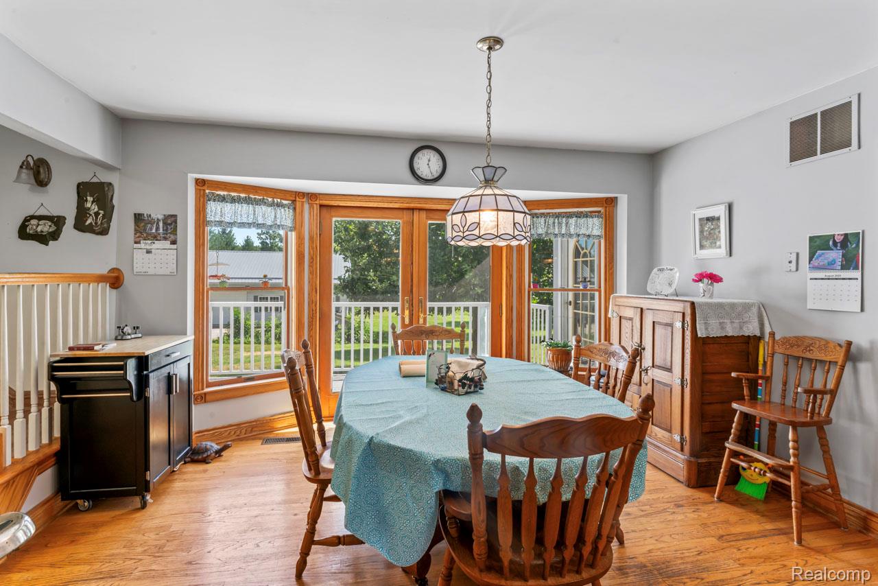 1591 Baldwin Road Lapeer, MI 48446 - Photo 8 of 46 Dining room featuring light wood-style floors and baseboards