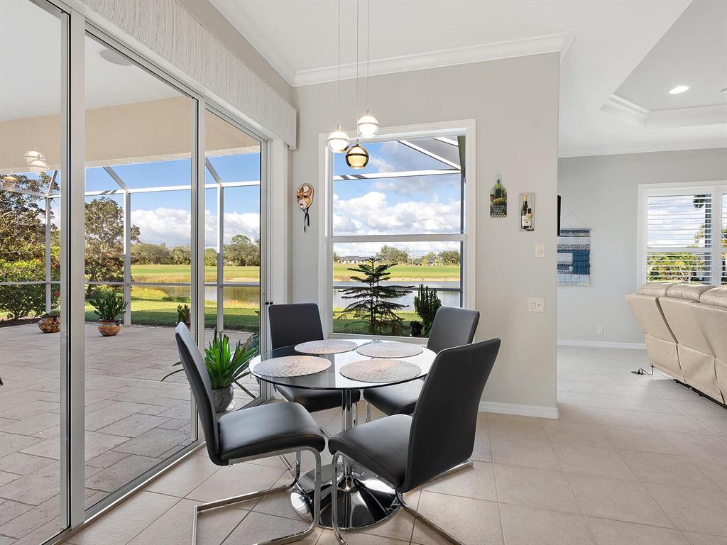 814 Adonis Place Venice, FL 34292 - Photo 12 of 38 a view of a dining room with furniture window and outside view