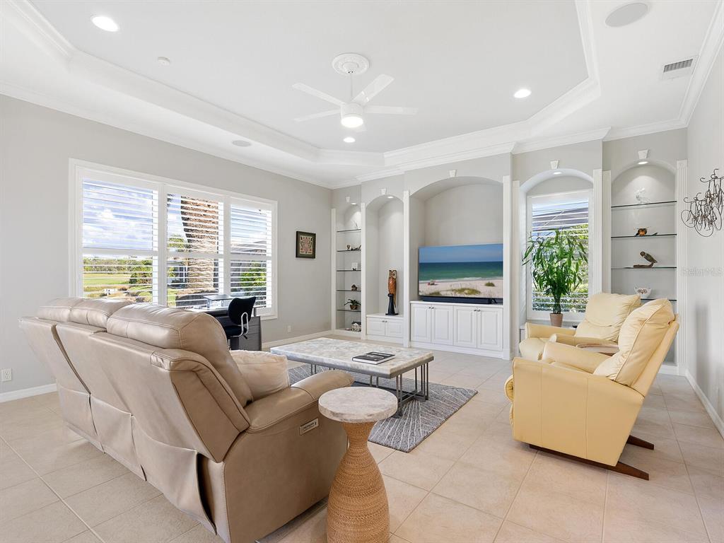814 Adonis Place Venice, FL 34292 - Photo 13 of 38 a living room with furniture and a large window