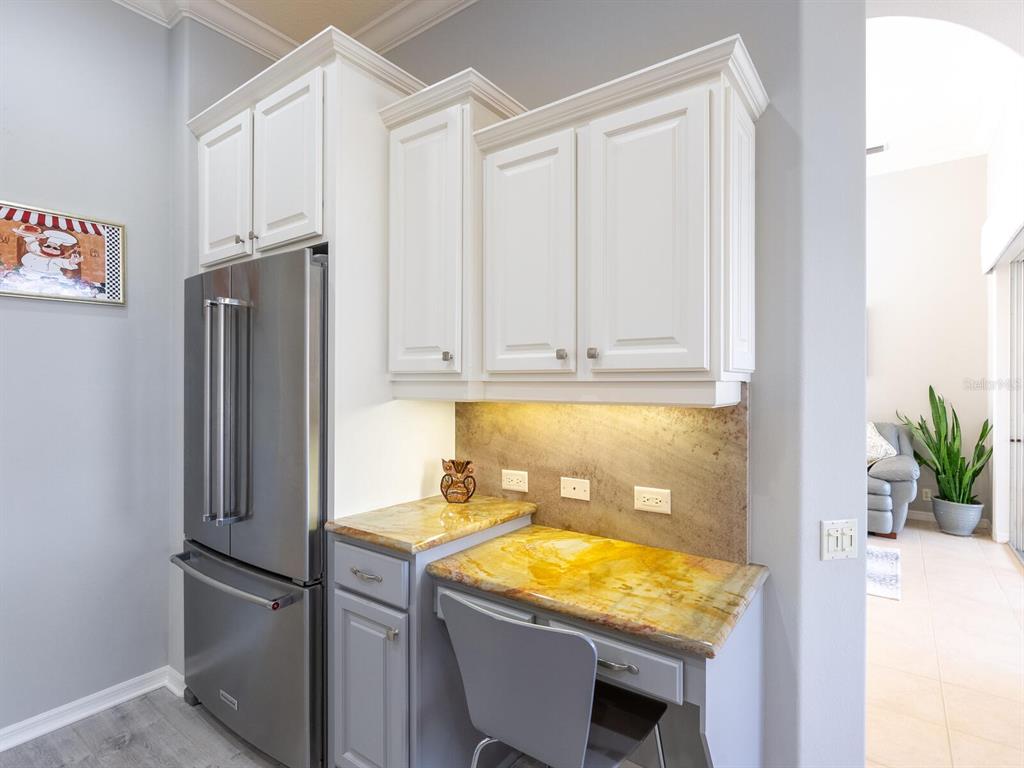 814 Adonis Place Venice, FL 34292 - Photo 20 of 38 a kitchen with stainless steel appliances granite countertop refrigerator sink and cabinets