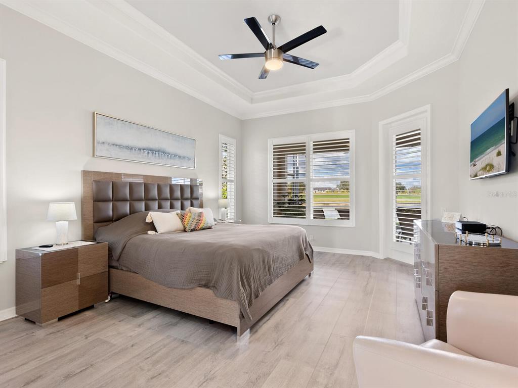 814 Adonis Place Venice, FL 34292 - Photo 21 of 38 a bedroom with a bed and a large window
