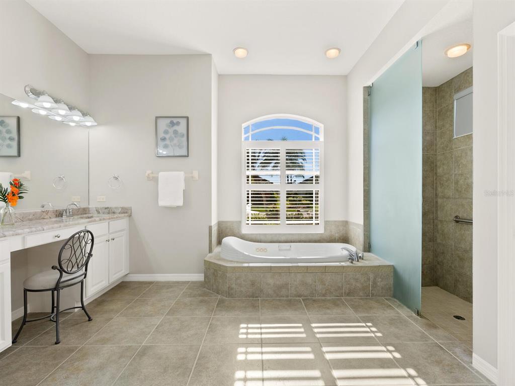 814 Adonis Place Venice, FL 34292 - Photo 23 of 38 a spacious bathroom with a tub sink and mirror