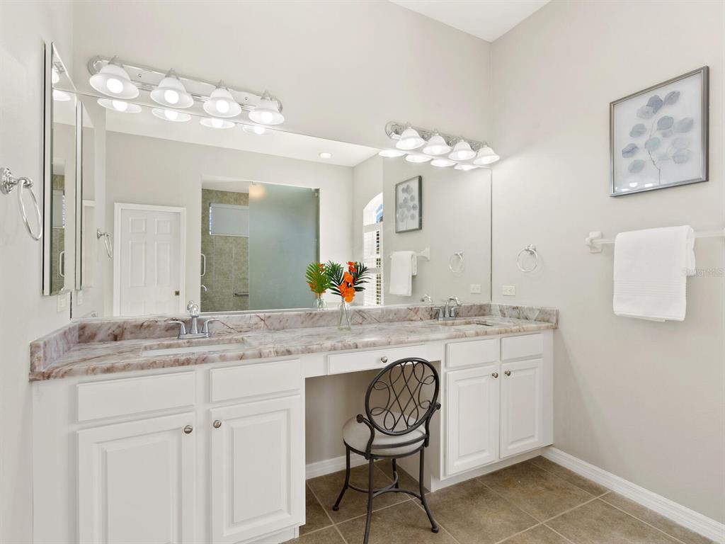 814 Adonis Place Venice, FL 34292 - Photo 25 of 38 a bathroom with a sink and a mirror