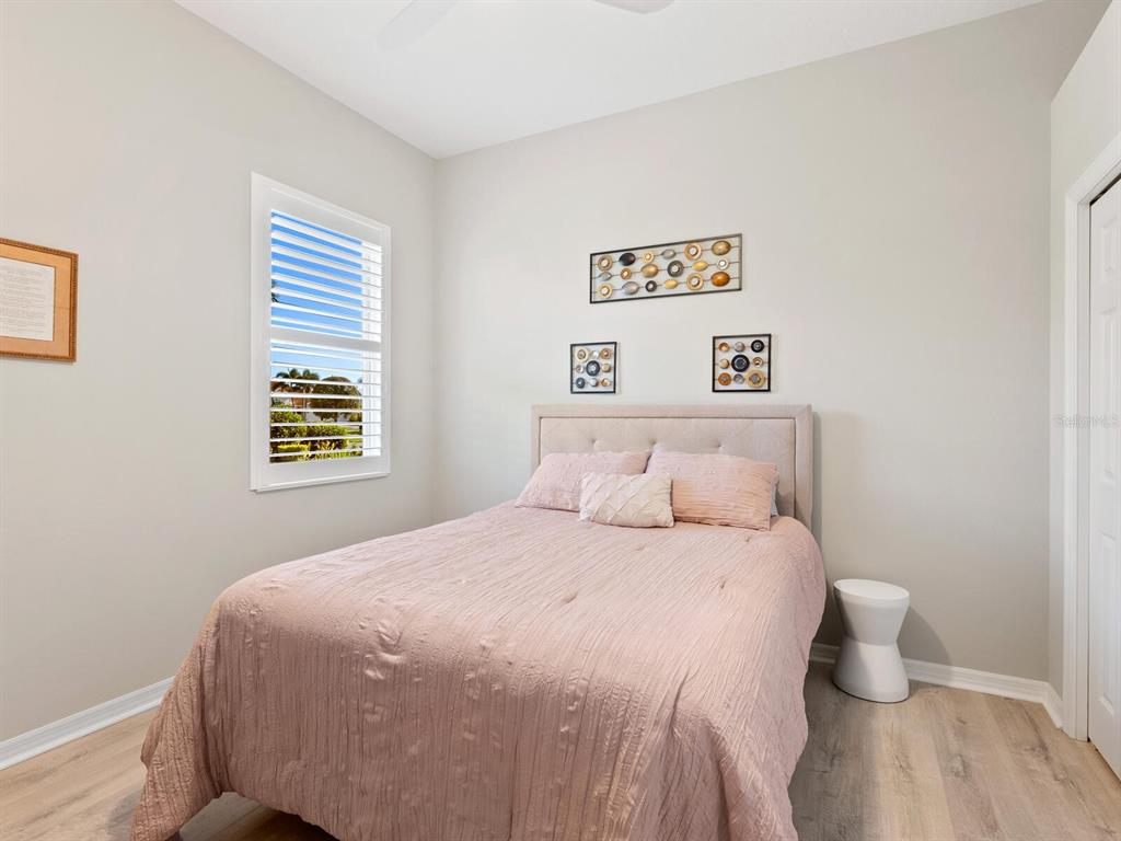 814 Adonis Place Venice, FL 34292 - Photo 26 of 38 a bedroom with a bed and a window
