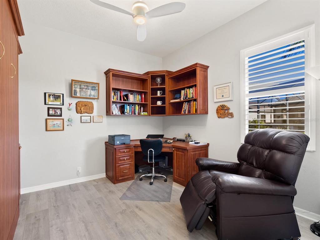 814 Adonis Place Venice, FL 34292 - Photo 28 of 38 a livingroom with workspace and a couch