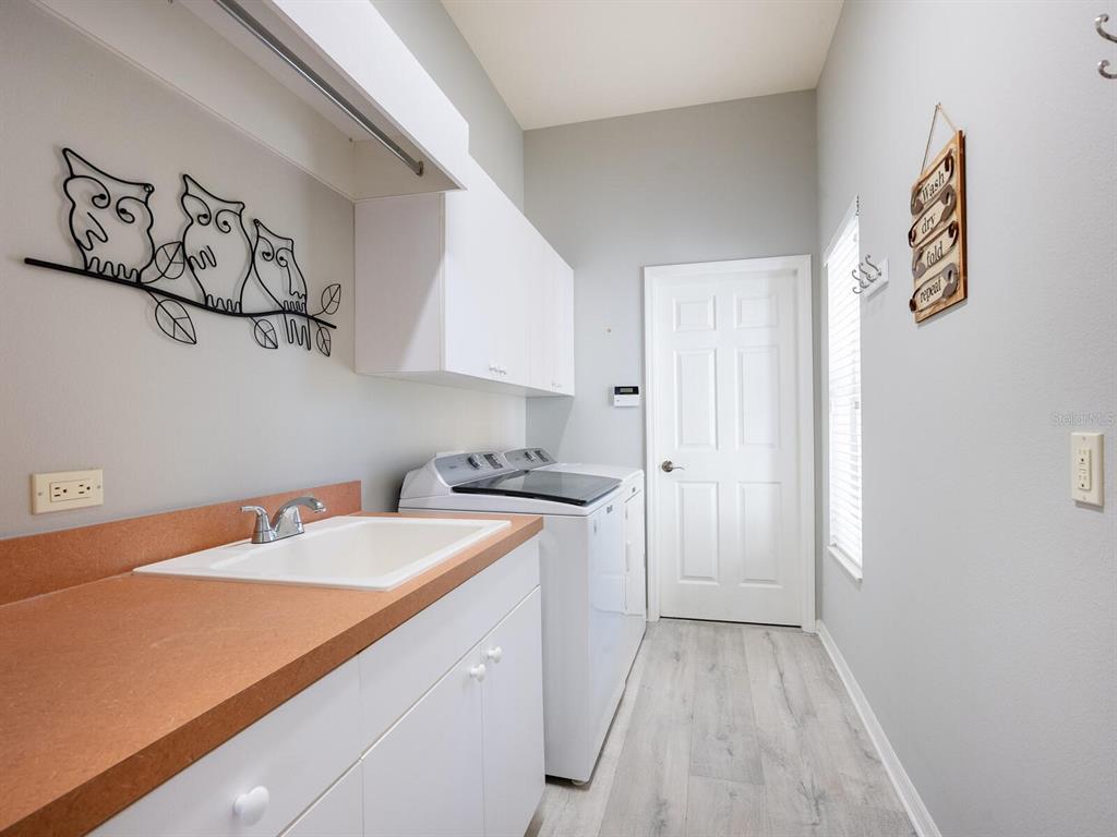 814 Adonis Place Venice, FL 34292 - Photo 29 of 38 a room with a sink and a stove top oven