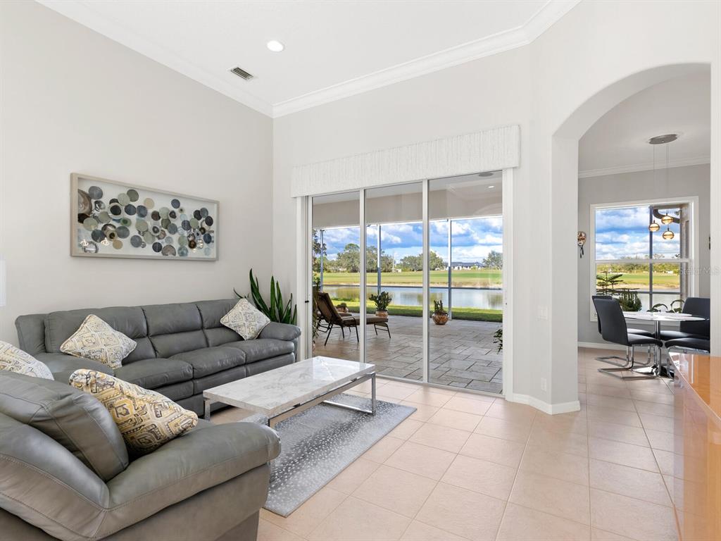 814 Adonis Place Venice, FL 34292 - Photo 4 of 38 a living room with furniture a dining table and chairs