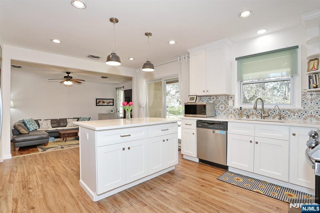 7 Tufts Court Paramus, NJ 07652 - Photo 15 of 50 a large white kitchen with a lot of counter space and wooden floor